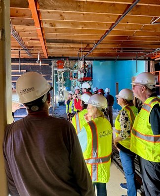 Rotarians in safety gear walking through the new community space