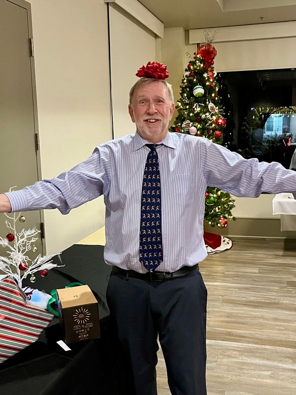 Doug at the club Christmas party with a ribbon on his head