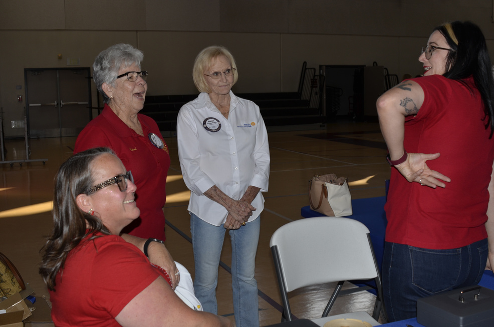 Rotarians and guests gathered near the gift-basket tables