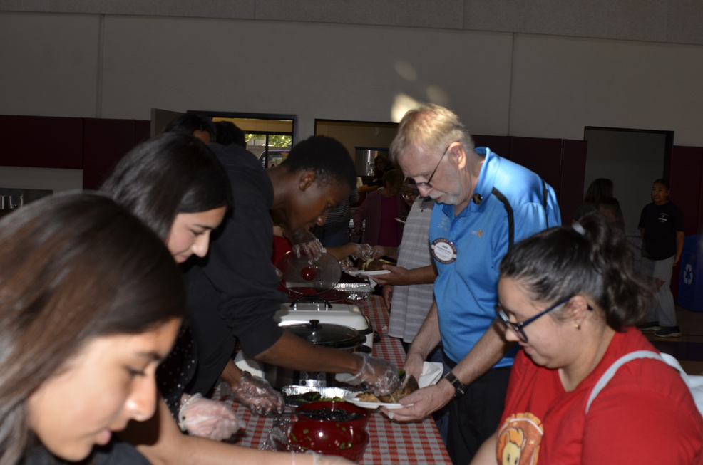 Volunteers serving guests at the Cherry Jubilee dining tables