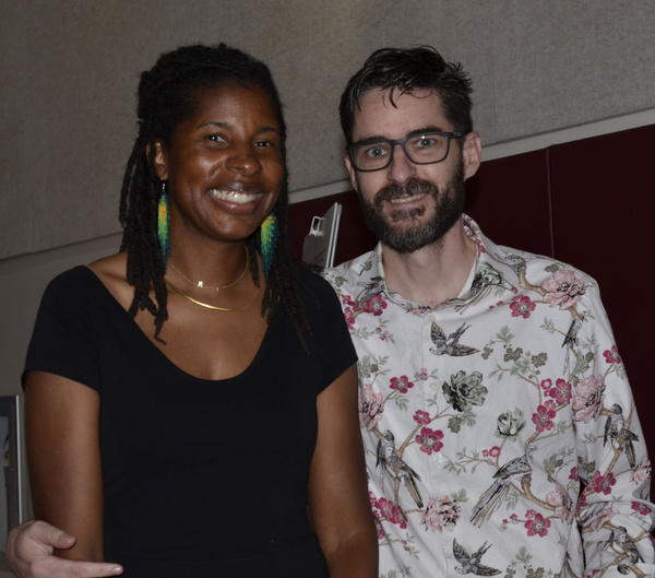 Two attendees smiling together at the event